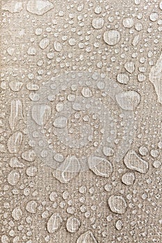 Texture of water drops on fabric textile close-up. Rain background