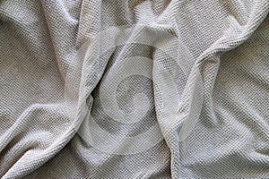 Texture of a wavy surface of a yellow terry fabric as a background