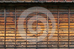 Texture of weathered traditional wooden wall in dark brown color