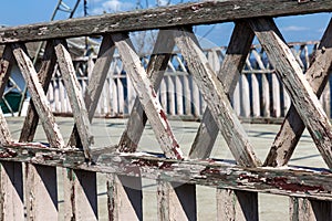 Texture of weathered wooden wall. An aged wooden fence made from plank vertical flat planks. Background of old wooden cross fence