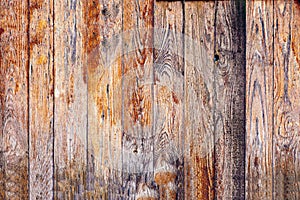 The texture of weathered wooden wall. Aged wooden plank fence of flat boards