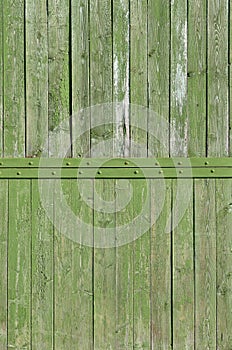 The texture of weathered wooden wall. Aged wooden plank fence of vertical flat board