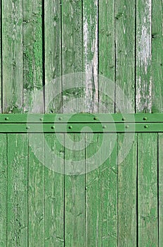 The texture of weathered wooden wall. Aged wooden plank fence of vertical flat board