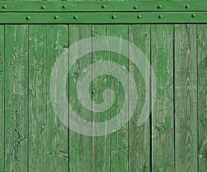 The texture of weathered wooden wall. Aged wooden plank fence of vertical flat board