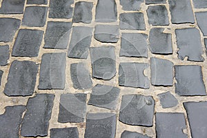 The texture of wet cobblestone pavement. Background for bridge old cities. The skill of a mason