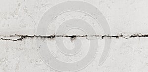 Texture white concrete wall has cracks