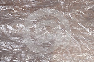 Texture of white crumpled cellophane surface transparent on sunlight. Concept of materials for packaging, product protection