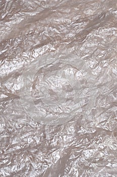 Texture of white crumpled cellophane surface transparent on sunlight. Concept of materials for packaging, product protection