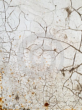 Texture of white paint with cracks and rust on metal surface, background