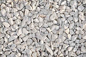 Texture of white pebbles. Small stones on the ground for landscape design.