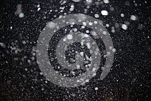 Texture of white rain drops on a black background