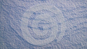 Texture of white snow with natural roughness.