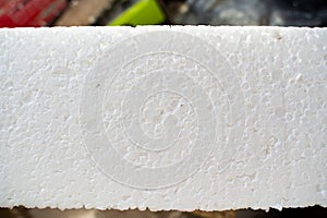 Texture of white styrofoam close-up. Universal insulation material made of expanded polystyrene