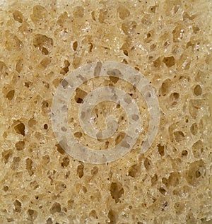 The texture of wholemeal bread as a background, close-up.