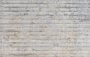 Texture of wooden formwork stamped on a raw concrete wall