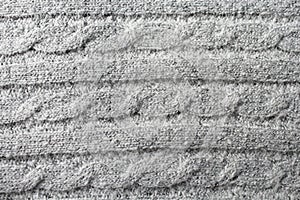 Texture wool, knitted material witha pattern `pigtail`, drai,  close-up. photo