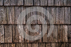 Texture of worn wooden roof tile pattern, detail of a typical old slovenian alpine cottage roofing