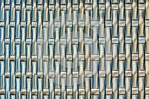 The texture of woven plant bark is metallic in color. Smooth wood texture of wicker bamboo of grey color. Symmetric background