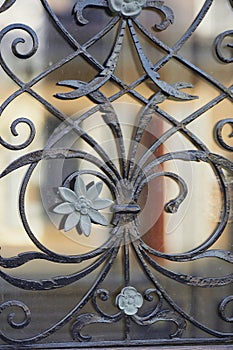 The texture of the wrought-iron grille on the window.Close. Artistic forging