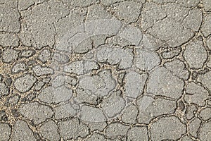 Textured backdrop. Mosaic texture, background of an old, cracked road. An old asphalt surface, background. Detailed texture