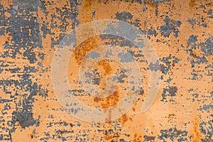 Textured background of a faded yellow paint with rusted cracks on rusted metal. Grunge texture of an old cracked metal