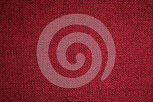 Textured background surface of textile upholstery furniture close-up. red Color fabric structure