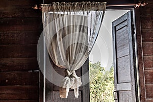 Textured background: Wooden pattern of Window and White lace curtains in traditional thai house