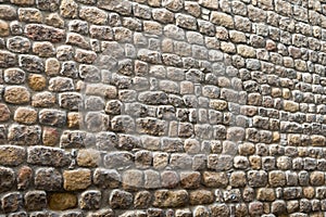 Textured biased ancient stone wall of a historical building