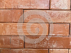 Textured Brick Wall Background with Brown Hardwood Floor, red brick wall, red wall