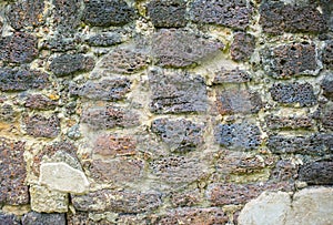 Textured brick wall. The ruins of ancient stone architecture