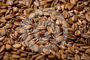 Textured brown flax seeds close-up background