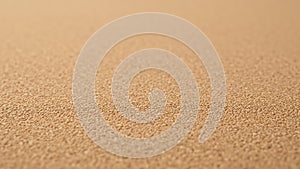 A textured close up view of a cork surface with a uniform pattern
