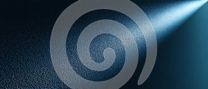 Textured dark blue surface illuminated by a bright diagonal light beam image