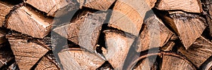textured firewood background of chopped wood for kindling and heating the house. a woodpile with stacked firewood. the texture of