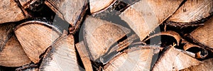 vtextured firewood background of chopped wood for kindling and heating the house. a woodpile with stacked firewood. the texture of