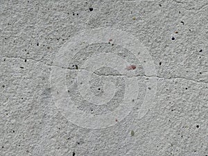 Textured gray concrete wall with a crack.