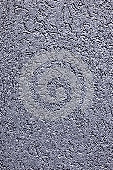Textured gray concrete wall surface with rough, irregular patterns suitable as a background