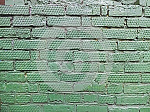 Textured green brick wall