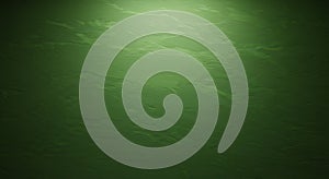 A textured green wall with a subtle gradient effect, showing variations in light and