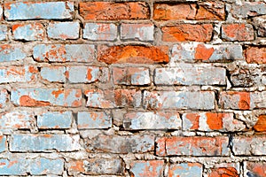 Textured grunge background of old red stone brick wall, close-up. Horizontal brickwork outdoors