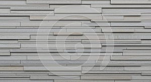 Textured Light Gray Stone Wall with Horizontal Rectangular Slat Pattern background