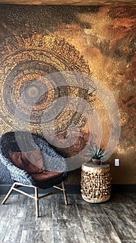 Textured mandala mural in rustic-themed lounge area photo