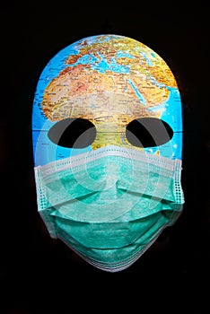 Textured mask with map  wearing surgical mask. Concept for corona virus pandemia