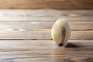 A textured ovular object rests on a rustic wooden surface. Generative AI
