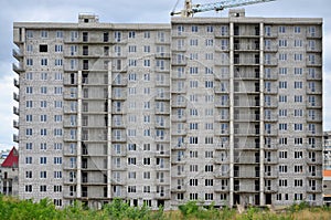 Textured pattern of a russian whitestone residential house building wall with many windows and balcony under constructio