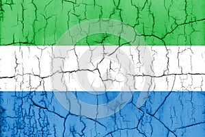 Textured photo of the flag of Sierra Leone with cracks.