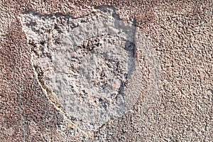 Textured plaster cement wall with cracks and stains