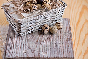 Textured spring background with small quail eggs. Eco products. Horizontal format