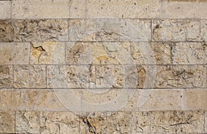 Textured stone wall close-up. The background. Limestone.