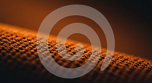 Textured surface in close-up, featuring a grid-like pattern with raised, evenly spaced